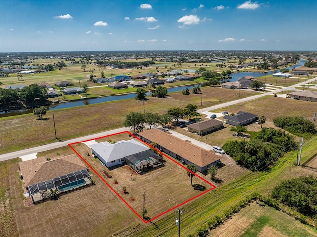birds eye view of property featuring a water view and a residential view