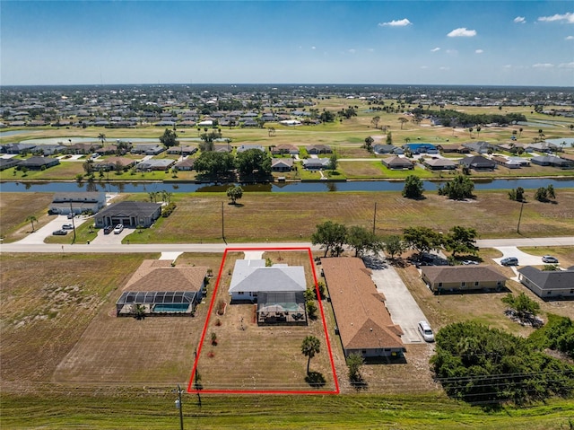birds eye view of property featuring a water view and a residential view