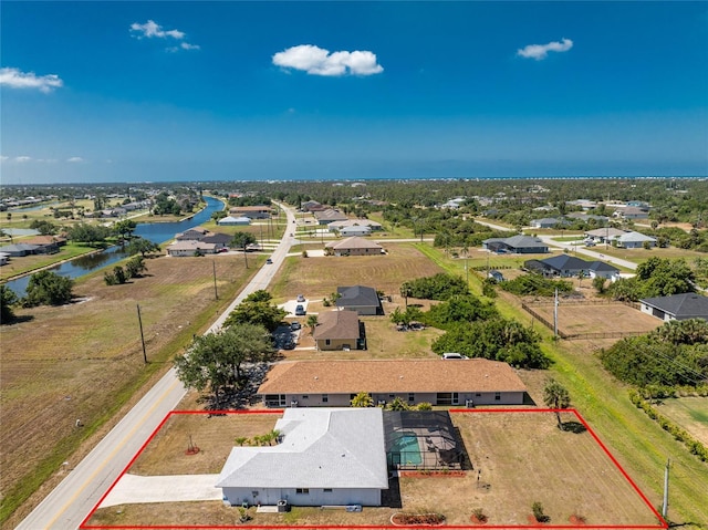 drone / aerial view with a water view and a residential view