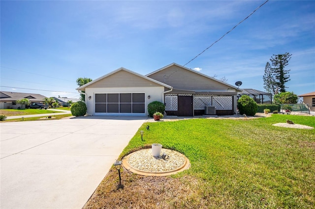 ranch-style house with an attached garage, driveway, central AC unit, and a front yard