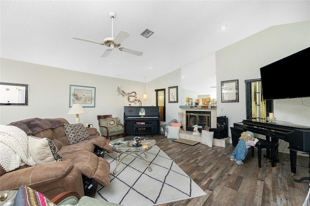 living area with ceiling fan, vaulted ceiling, wood finished floors, and visible vents