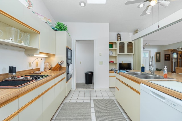 kitchen with light countertops, open shelves, a sink, and dishwasher
