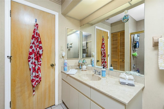 bathroom with a closet, tile patterned floors, and vanity
