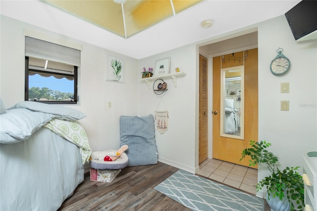 interior space with baseboards, wood finished floors, and a closet
