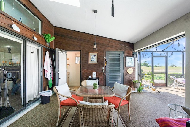 sunroom with outdoor dining area