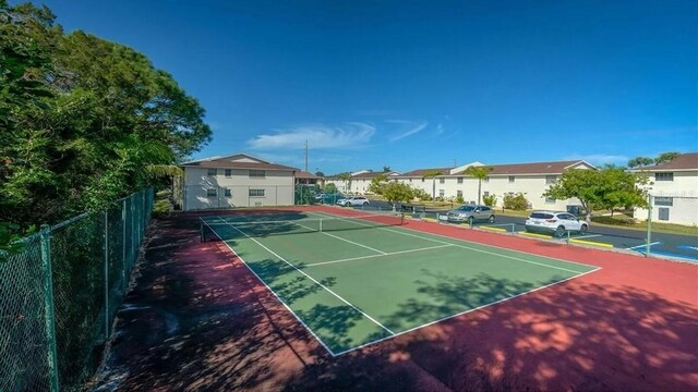 1531 Placida Rd Unit 4-103, Englewood, FL 34223 - view of tennis court with a residential view and fence