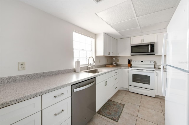 1531 Placida Rd Unit 4-103, Englewood, FL 34223 - kitchen with stainless steel appliances, a sink, white cabinetry, light tile patterned flooring, and light countertops