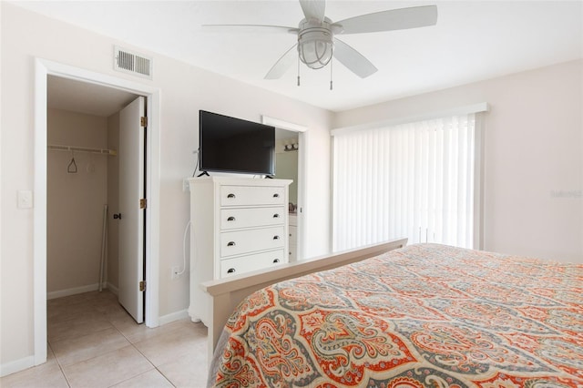 1531 Placida Rd Unit 4-103, Englewood, FL 34223 - bedroom featuring a walk in closet, light tile patterned floors, baseboards, ceiling fan, and a closet