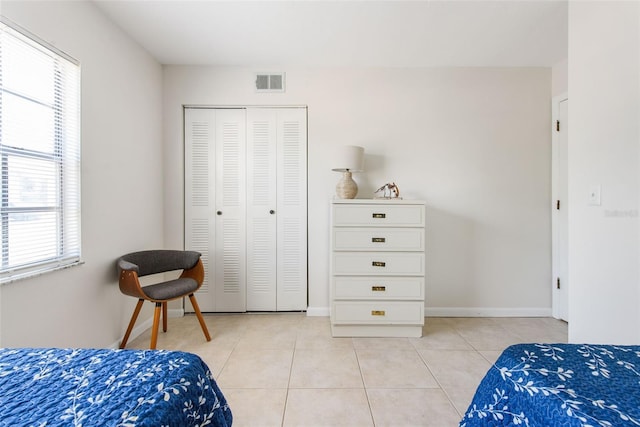 1531 Placida Rd Unit 4-103, Englewood, FL 34223 - bedroom with light tile patterned floors, multiple windows, a closet, and baseboards