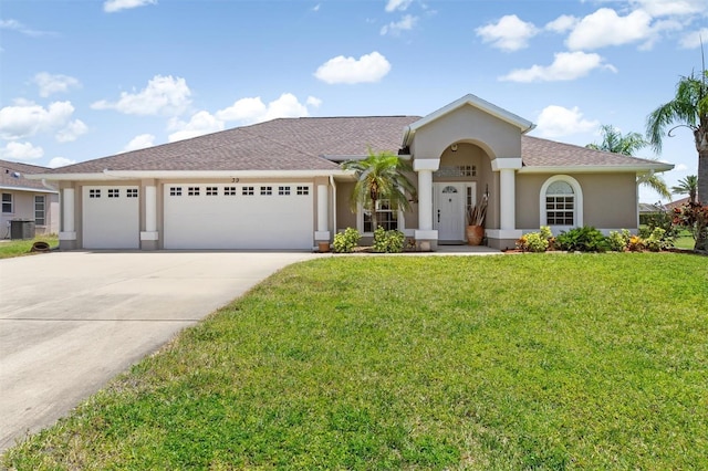view of front of property with driveway, a garage, central air condition unit, a front lawn, and stucco siding