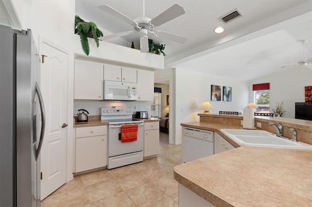 kitchen featuring a ceiling fan, visible vents, a sink, white appliances, and white cabinetry