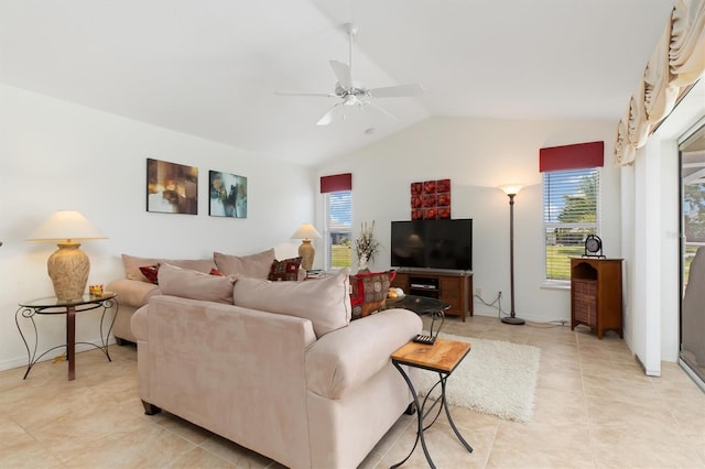 living room featuring a ceiling fan, light tile patterned floors, vaulted ceiling, and a healthy amount of sunlight