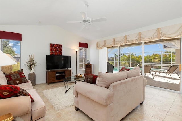 living room featuring a healthy amount of sunlight, ceiling fan, light tile patterned flooring, and lofted ceiling