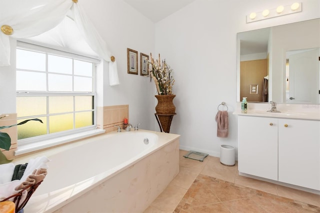 bathroom with tile patterned floors, a bath, and vanity
