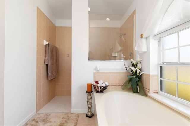 bathroom with a walk in shower, tile patterned floors, recessed lighting, baseboards, and a garden tub