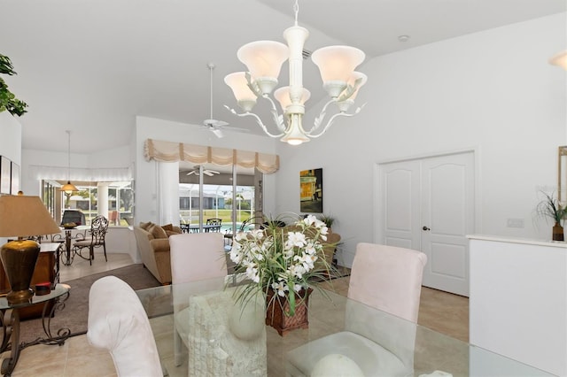tiled dining area with a high ceiling and an inviting chandelier