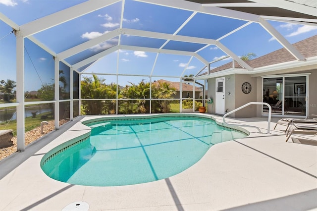 outdoor pool with a lanai and a patio area