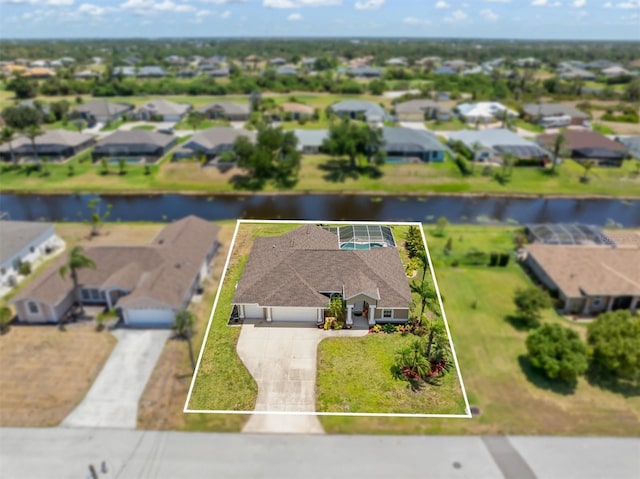 drone / aerial view with a water view and a residential view
