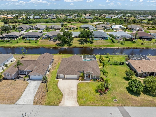 bird's eye view featuring a residential view and a water view