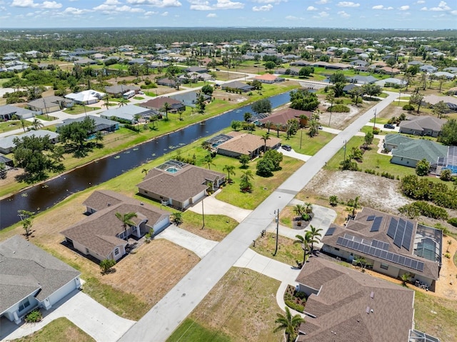 drone / aerial view featuring a water view and a residential view