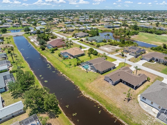 birds eye view of property featuring a water view and a residential view