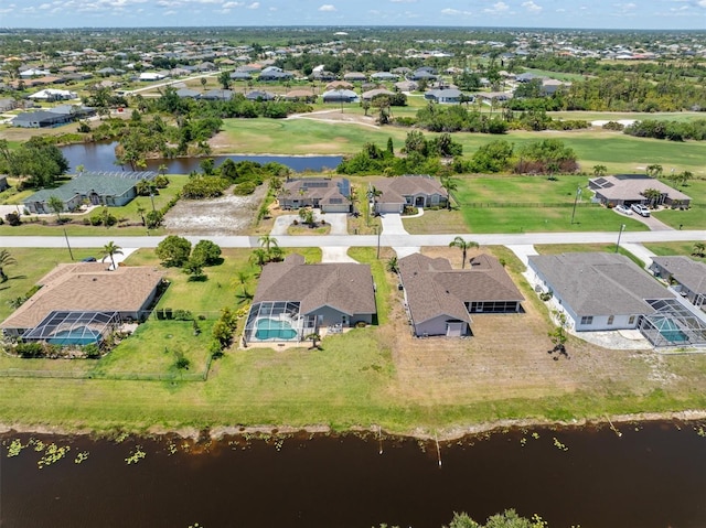 drone / aerial view with a water view and a residential view