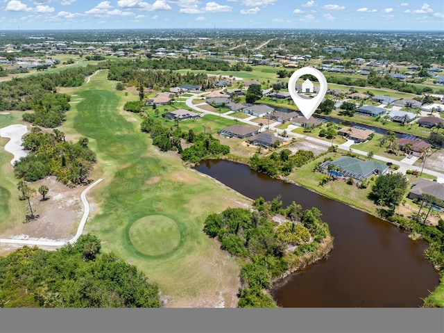 drone / aerial view featuring a residential view, view of golf course, and a water view
