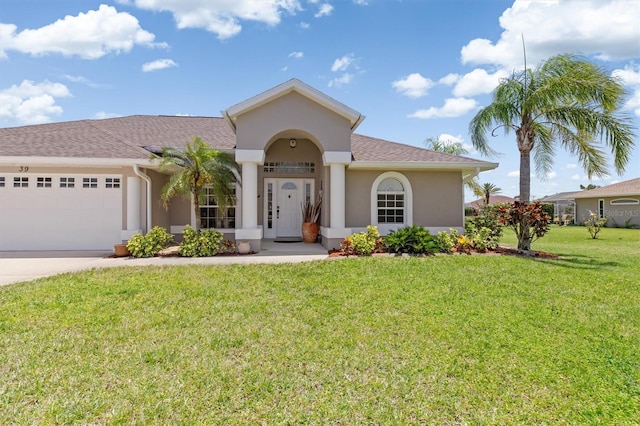 view of front facade with a garage, a front lawn, stucco siding, a shingled roof, and driveway