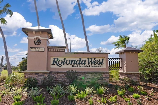 community sign featuring fence