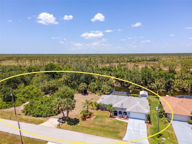 drone / aerial view featuring a forest view
