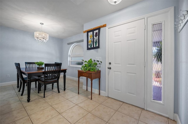dining room featuring a chandelier, baseboards, and light tile patterned floors