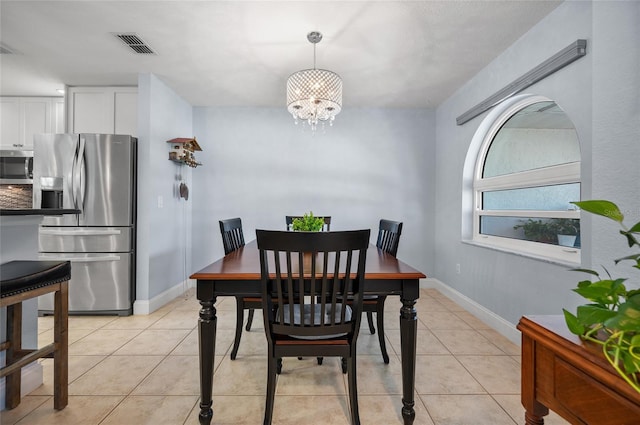dining room featuring a chandelier, light tile patterned flooring, baseboards, and visible vents