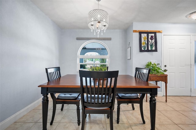 dining area with an inviting chandelier, baseboards, and light tile patterned floors