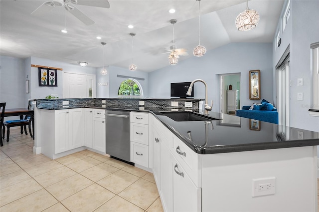 kitchen featuring stainless steel dishwasher, open floor plan, ceiling fan, and a sink