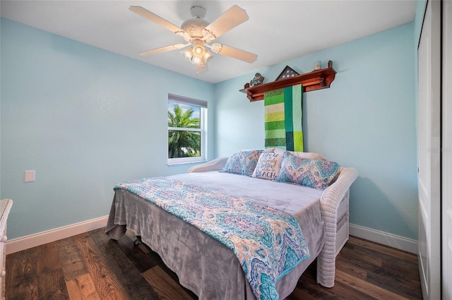 bedroom featuring baseboards, a ceiling fan, and wood finished floors