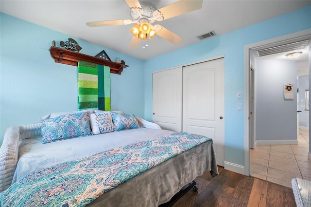 bedroom featuring baseboards, a closet, and visible vents