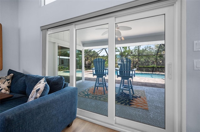doorway to outside with a wealth of natural light, a ceiling fan, and wood finished floors