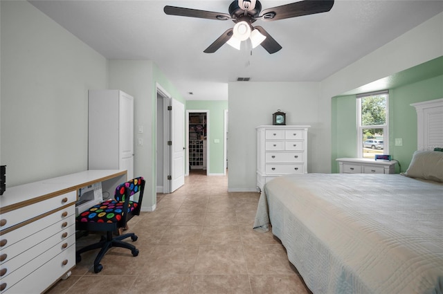 bedroom featuring light tile patterned floors, visible vents, baseboards, and a ceiling fan