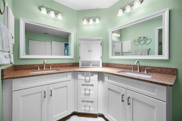 bathroom with a sink and double vanity