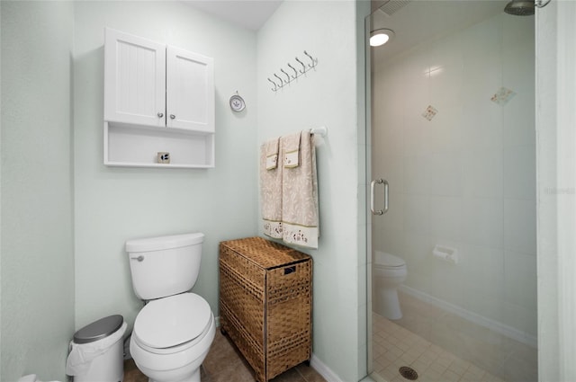 full bathroom with toilet, tile patterned flooring, and a shower stall