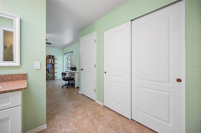 hall featuring light tile patterned flooring