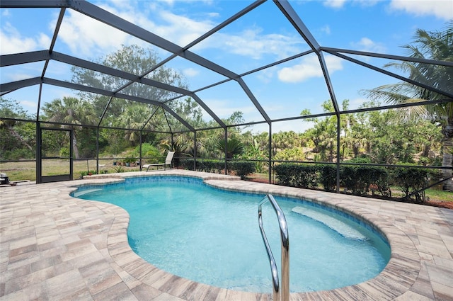 pool with a patio area and glass enclosure