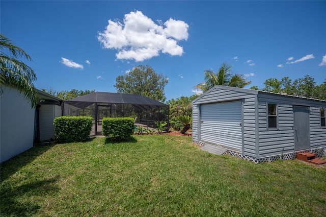 view of yard with a storage shed, an outdoor structure, and glass enclosure