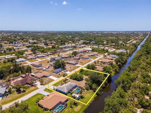 drone / aerial view with a water view and a residential view