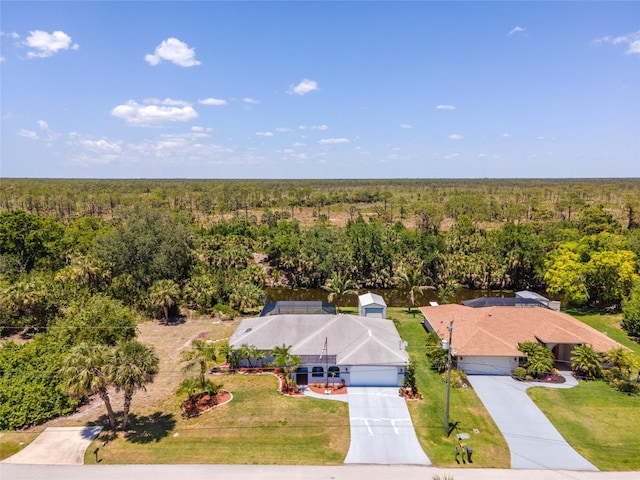 birds eye view of property with a wooded view