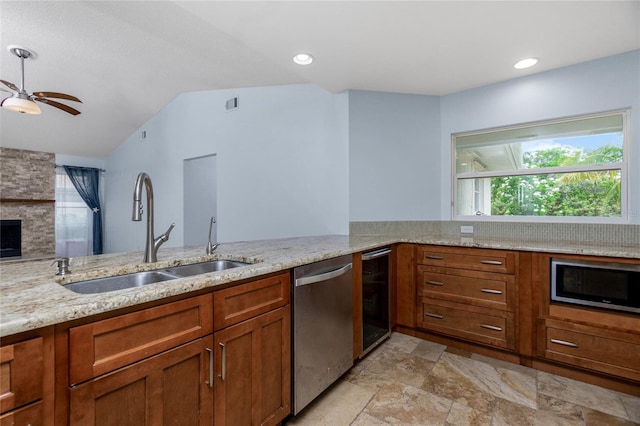 1155 Osceola Blvd, Englewood, FL 34223 - kitchen featuring a sink, brown cabinetry, appliances with stainless steel finishes, light stone counters, and wine cooler