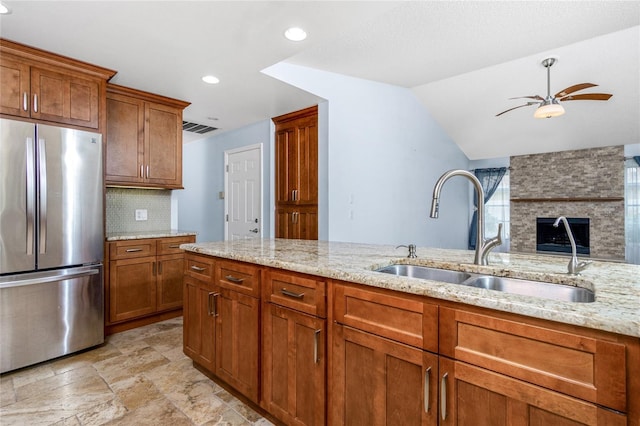 1155 Osceola Blvd, Englewood, FL 34223 - kitchen featuring freestanding refrigerator, brown cabinetry, a ceiling fan, and a sink