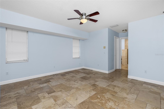 1155 Osceola Blvd, Englewood, FL 34223 - unfurnished room with baseboards, a ceiling fan, and stone tile flooring