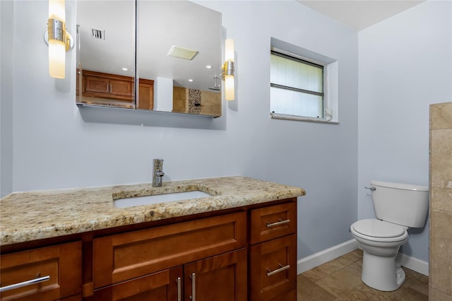 1155 Osceola Blvd, Englewood, FL 34223 - bathroom featuring vanity, toilet, baseboards, and visible vents