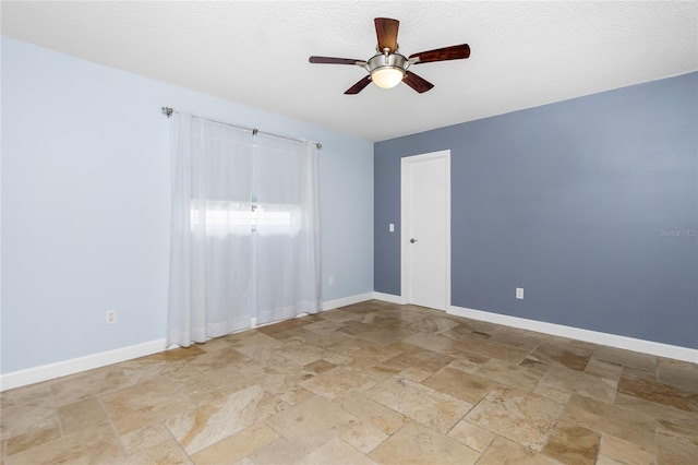 1155 Osceola Blvd, Englewood, FL 34223 - spare room with ceiling fan, baseboards, and stone tile flooring